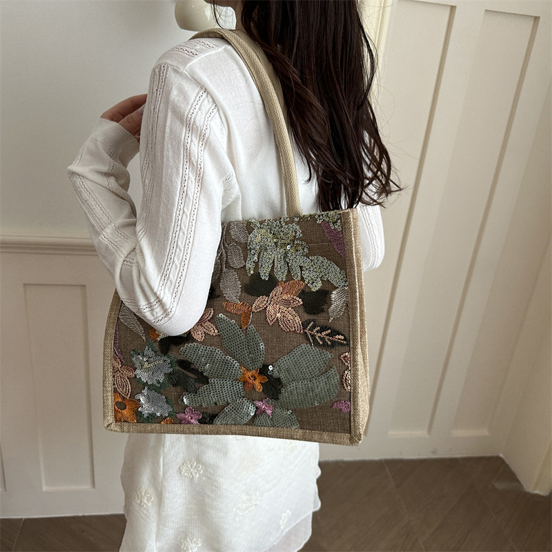 Explosiones transfronterizas 2026 textura de lino de alta calidad, flores bordadas, bolsas de tendencia horizontales, bolsas de compras de aire exterior