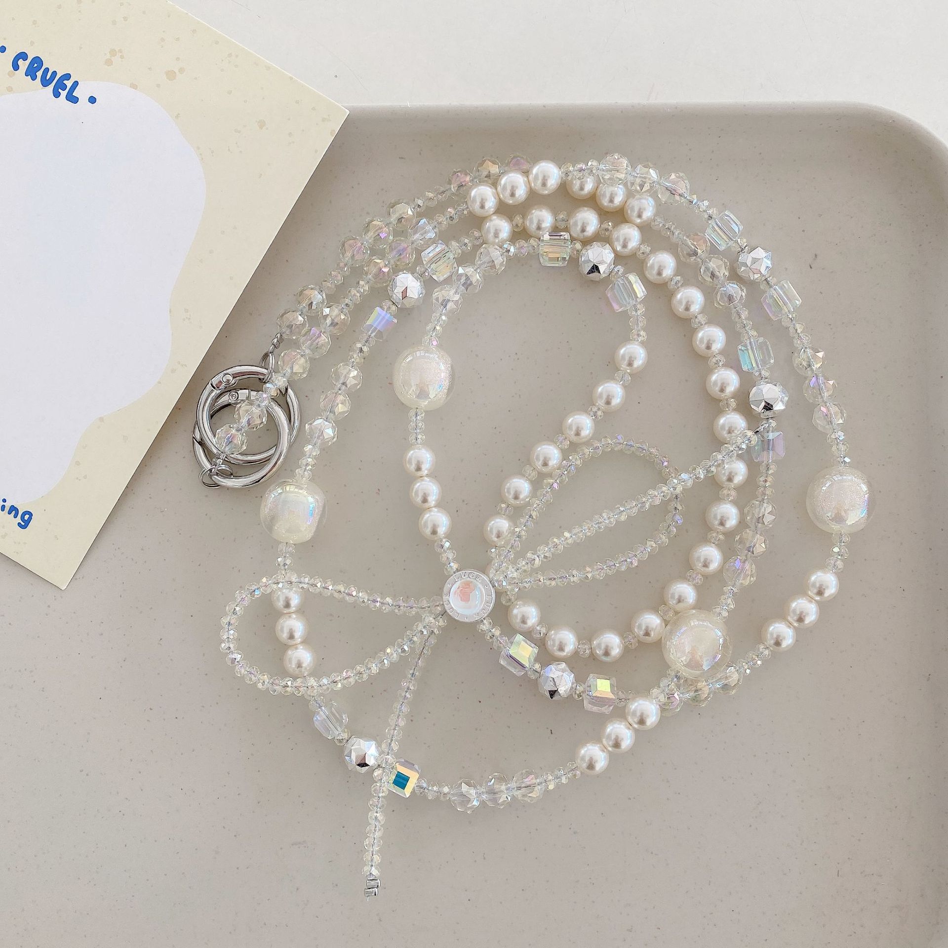 Boutique hecho a mano cadena colgante de alta gama arco fresco de cuatro colores cadena larga cordón de teléfono móvil de moda mensajero largo/colgante