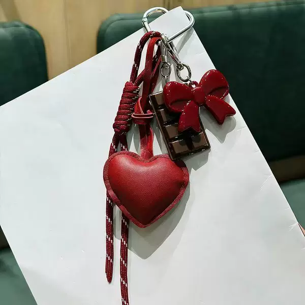 Creative PU leather heart-shaped keychain, a stylish accessory for women's bags and backpacks, featuring a MIU-style bow design