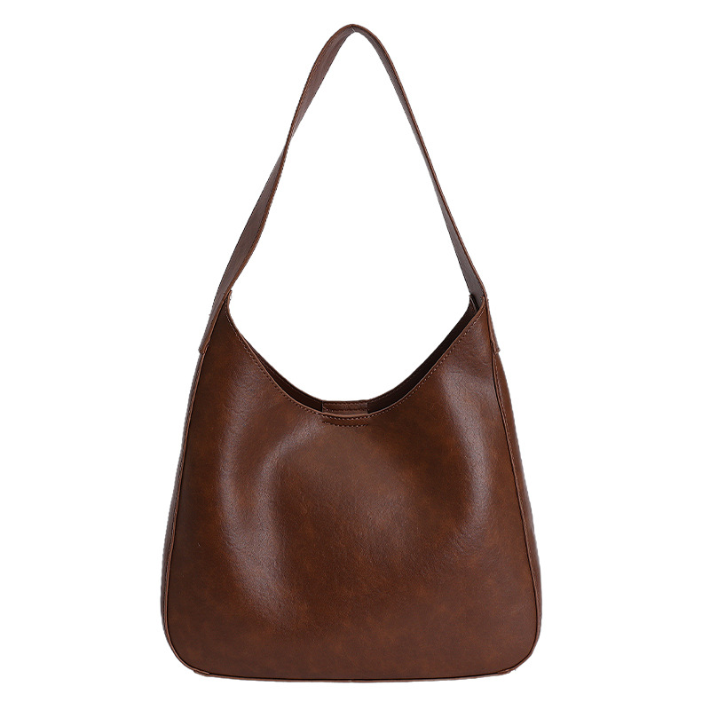 Nicho de diseño simple bolso de cubo portátil para mujeres 2026 primavera nueva moda perezosa retro bolso de brazo diario