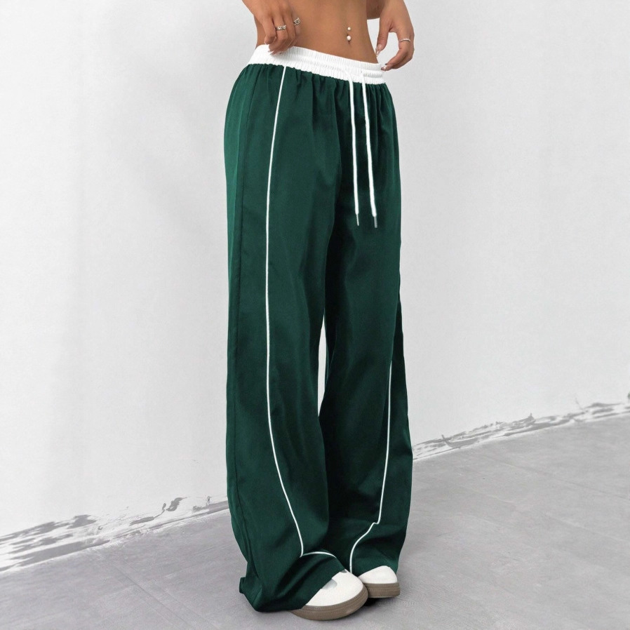 Europa y los Estados Unidos transfronterizos de otoño y invierno 2025 moda nuevos pantalones deportivos negros de mujer sueltos ociosos nichos de piernas largas