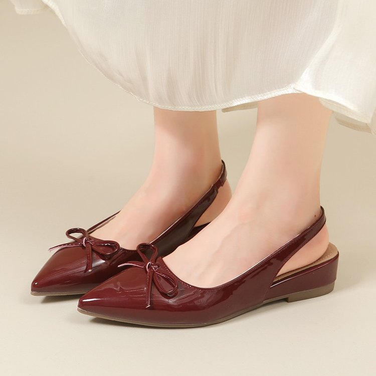 Zapatos de tacones planos transpirables para mujeres verano 2026 nuevo arco de estilo francés detrás de zapatos vacíos sandalias de punta para mujeres