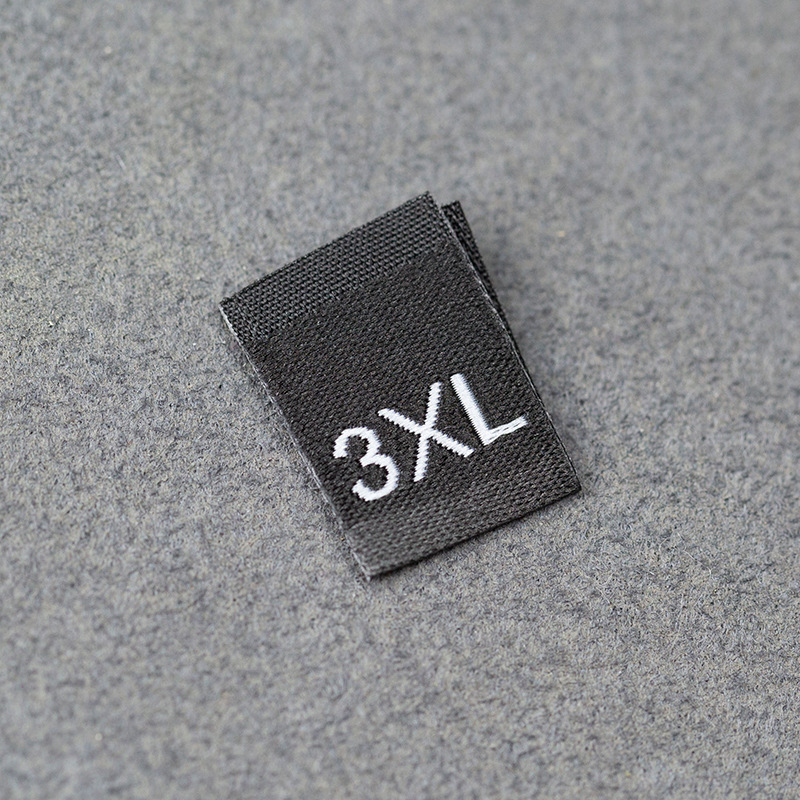 En stock Etiqueta de tamaño de alta densidad en blanco y negro Etiqueta de tamaño universal Etiqueta de código de letra inglesa Pantalones Etiqueta de código de cuello de camiseta