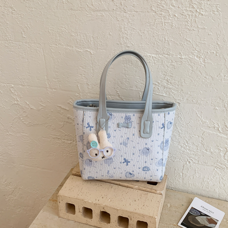 Fresco dulce popular impresión bolsos personalidad extranjera versátil bolsos de mochila de moda diaria bolsos de cubo portátiles