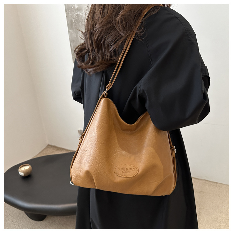 The 2024 new pleated tote bag is a large-capacity casual and fashionable backpack for women, featuring multi-functional texture and a single-shoulder crossbody bag undefined