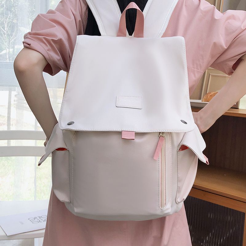 Large-capacity flip-top backpack for women, Korean style, trendy color-block design, suitable for students in middle and high school, simple and versatile for commuting and carrying a laptop