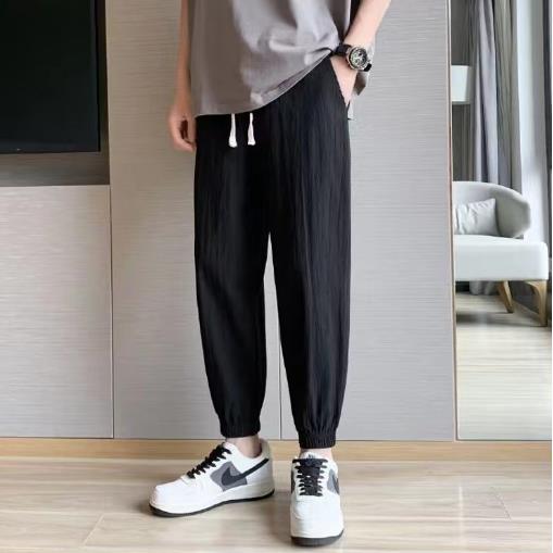 Pantalones de lino casuales para hombres de nuevo estilo con cordones sueltos de lino de algodón transpirable, tendencia juvenil, pantalones largos de talla grande de todo fósforo