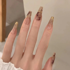 Mid-length ballerina nails with dark red autumn design, leaf silhouette artificial nails, French gold foil for a pale, retro look