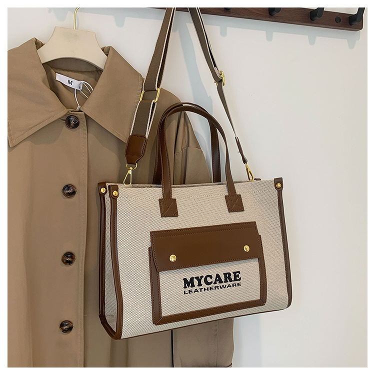 Bolso de lona de gran capacidad para mujeres 2024 nueva moda color contrastante empalme mochila de hombro simple bolsa de mano casual
