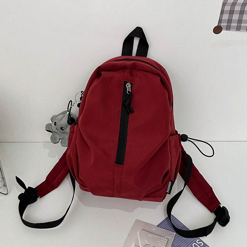 Mochila de viaje ligera al aire libre mochila de montaña de ocio simple de color sólido mochila de estudiantes de secundaria y secundaria gran capacidad