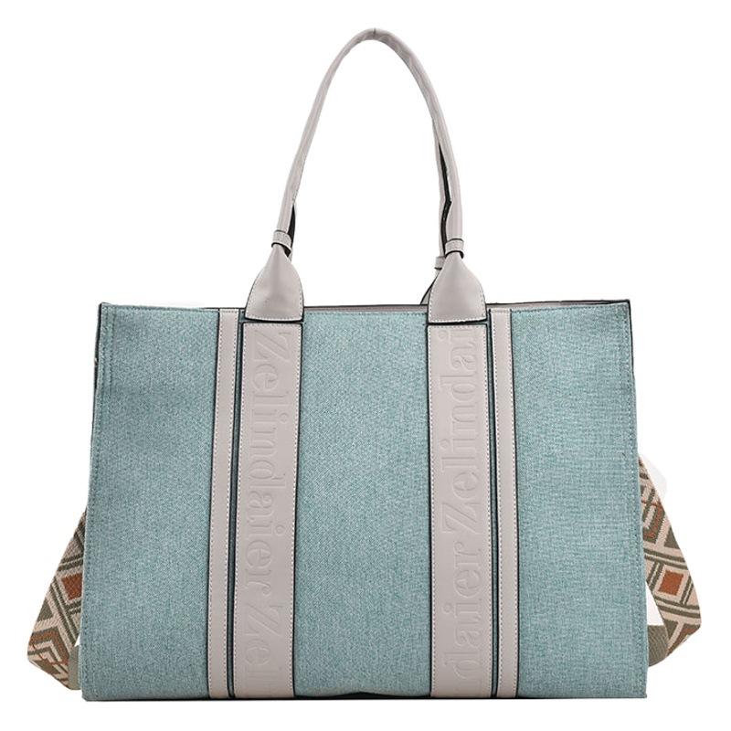 Bolso tote de lona de nuevo estilo con bloques de color, de gran capacidad para mujer, bolso cruzado de moda transfronteriza con sensación de alta gama para el trabajo y el transporte diario.