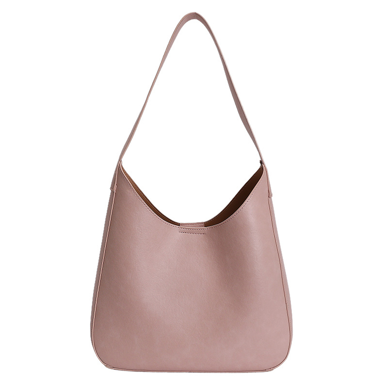 Nicho de diseño simple bolso de cubo portátil para mujeres 2026 primavera nueva moda perezosa retro bolso de brazo diario