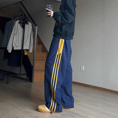 紺色のアメリカのレトロなストライプのズボンの男性の秋冬のタイプの潮のブランドの速乾の仕事の服装の突撃のズボンの運動のレジャーのズボン