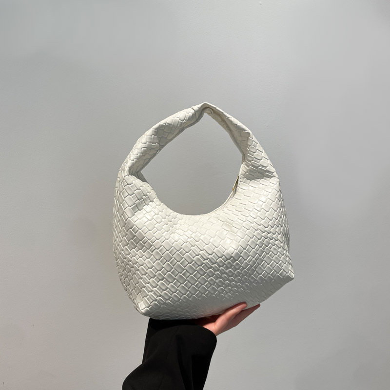 Bolsa de tejido francesa de alto nivel para mujeres 2025 nuevo bolso de bolsillo de nicho de textura de bolso de viaje de bolso de mano universal