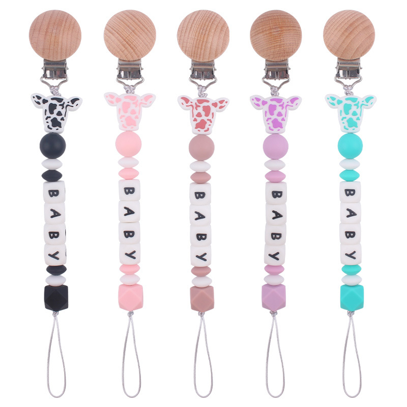 Nuevo bebé suministros de dibujos animados de silicona vaca cabeza mordedor creativo bebé DIY nombre mordedura pezón cadena anti-caída