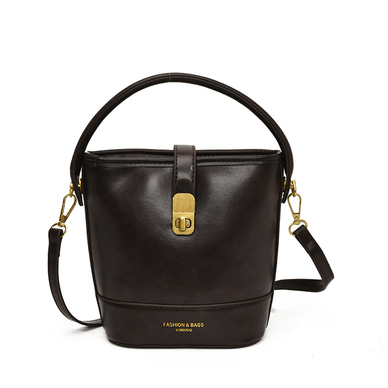 Bolso de mano de viaje retro para mujeres 2024 nuevo estilo simple bolso de hombro universal de moda alta sensación bolso de cubo