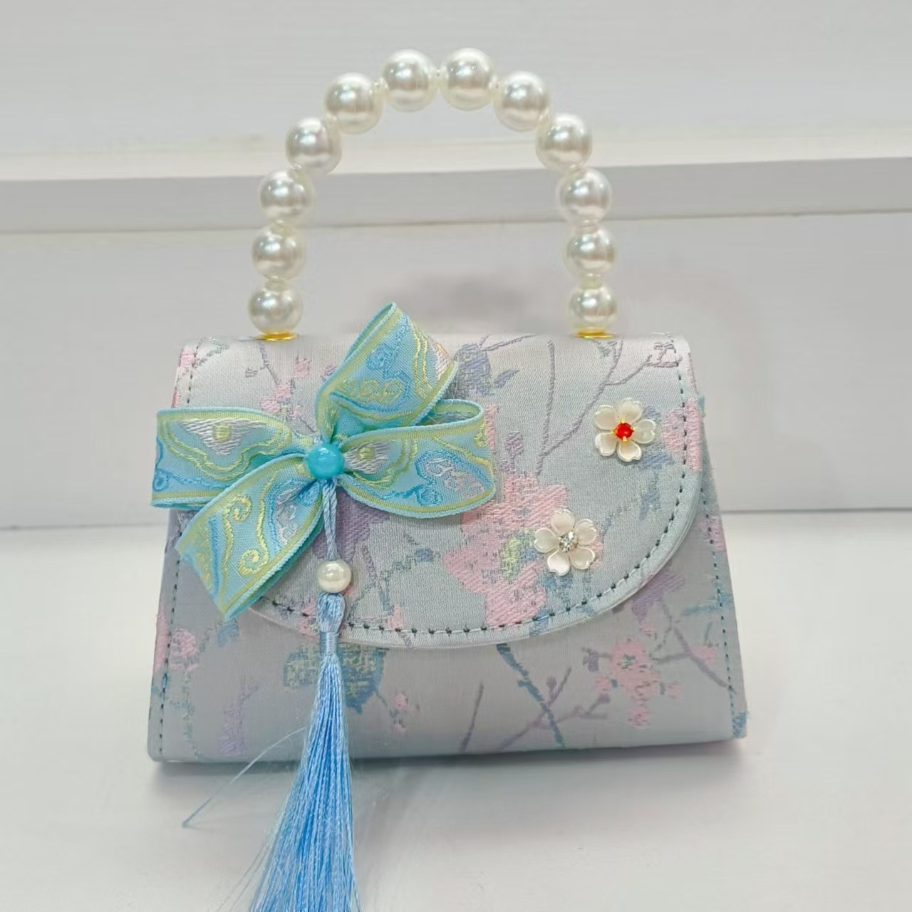 Bolsas de niños arco de estilo chino borda de niña pequeña princesa perla bolsa de cambio de mano al por mayor