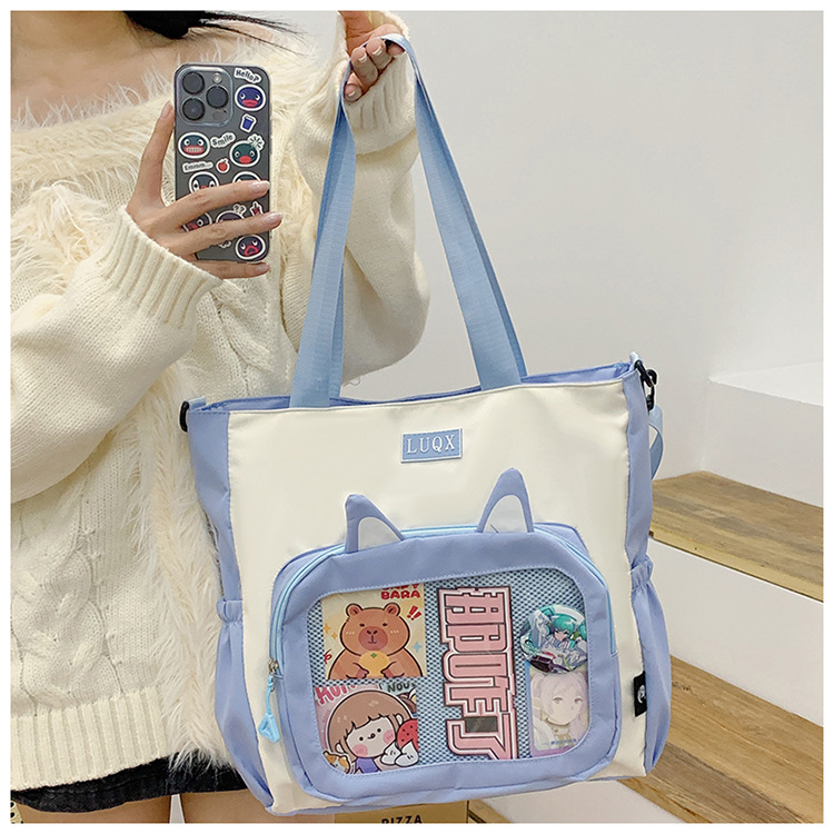 The new cute cartoon printed student bag with a large capacity and transparent student storage single-shoulder bag is selling well for women undefined