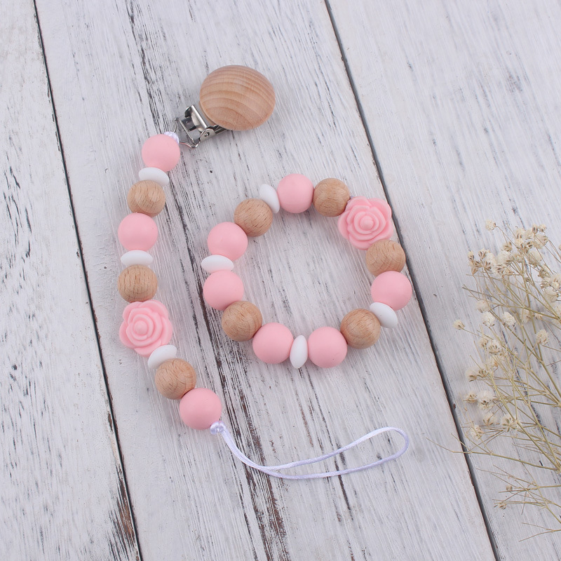 Nuevo bebé de dibujos animados de silicona de doble cara Rosa mordedor calmante bebé anti-gota cadena pulsera traje de juguete