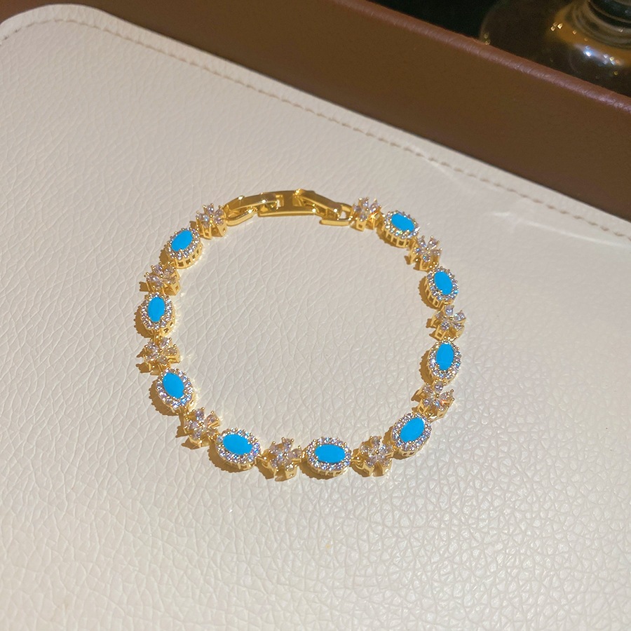 3 pulseras - doradas - azules