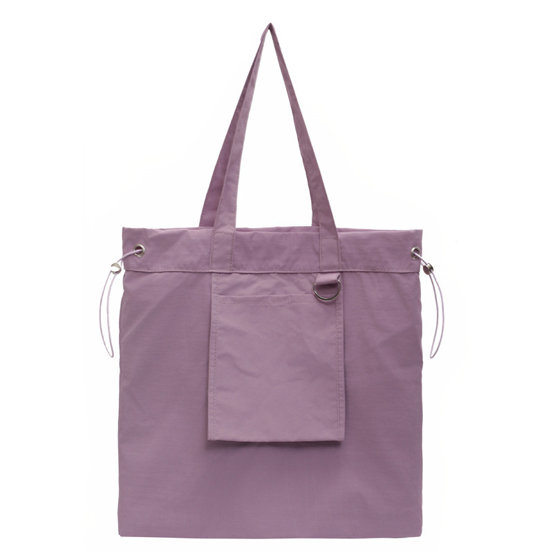 Bolsa de tela de nylon impermeable para mujeres 2025 nuevo tipo bolso de cubo de viaje ligero de gran capacidad bolso de hombro portátil para estudiantes universitarios