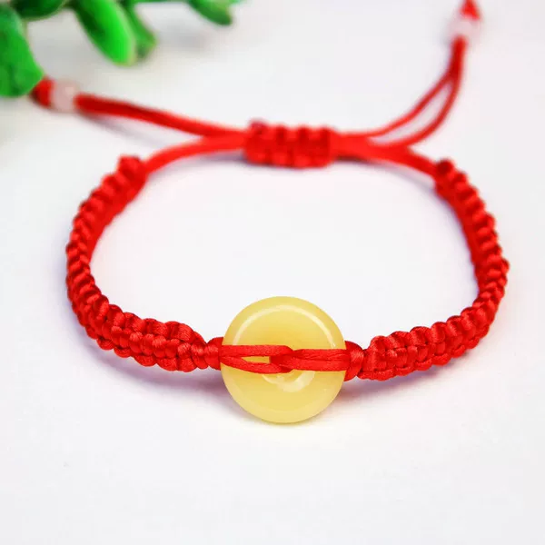 Red rope bracelet, yellow protective amulet, buckle