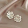 White ear clips, flowered