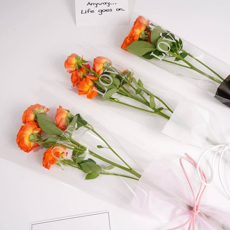 OPP英文单支袋玫瑰鲜花套袋防水花束袋花店花艺资材摆摊卖花