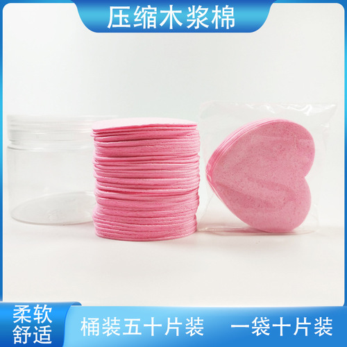 Compressed heart-shaped wood pulp cotton facial puff for washing face, cleansing, makeup removal, and powder application; can be soaked in water to transform into a large sponge facial puff.