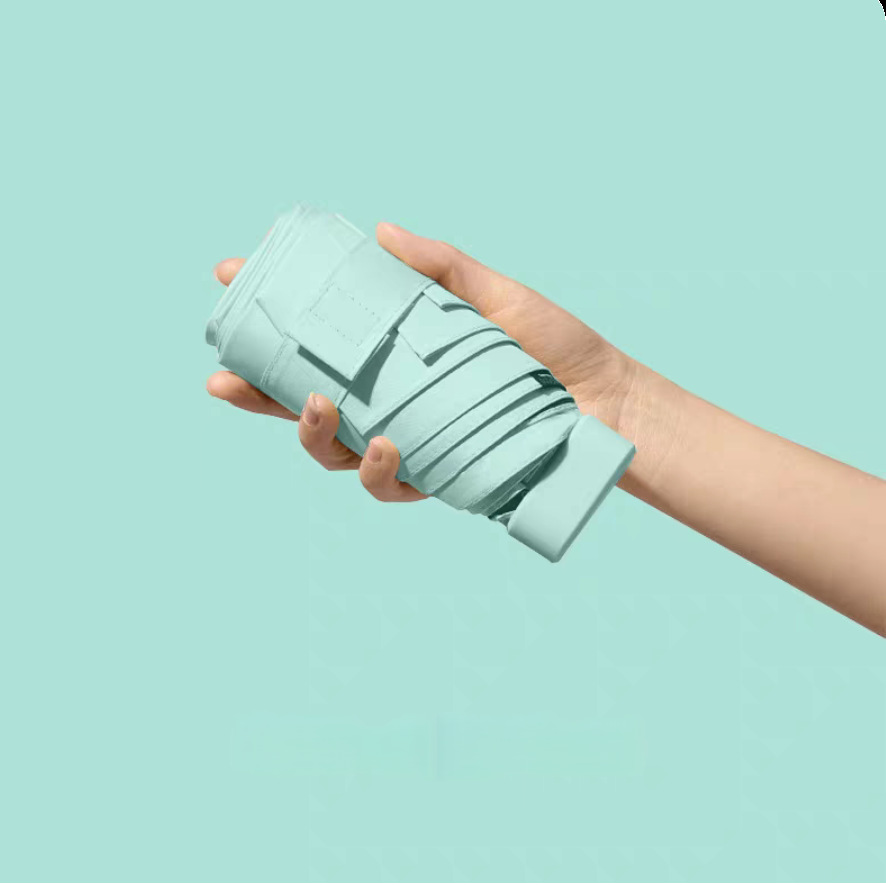 Capsule paraguas para mujeres sol y lluvia doble protección solar UV pequeño portable plegable mini paraguas al por mayor