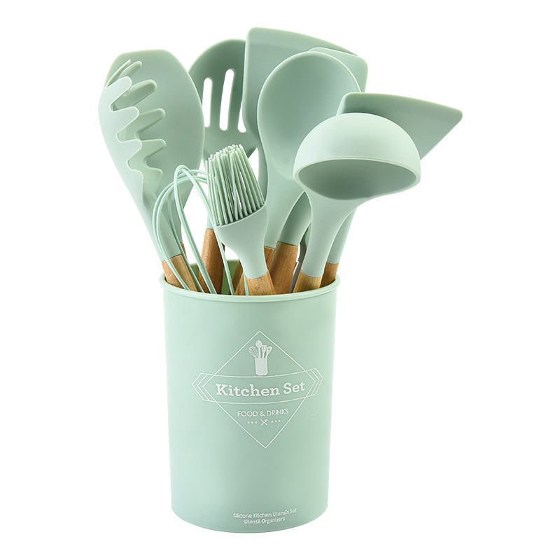 Traje de utensilios de cocina de silicona transfronteriza mango de madera sartén antiadherente de 12 piezas pala de cocina cuchara suministros de cocina espátula de silicona conjunto completo