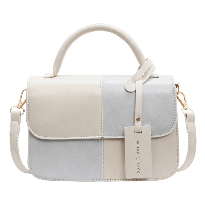 Bolso de mano coreano de color para mujeres 2025 nuevo nicho de textura universal bolso de hombro simple mochila casual