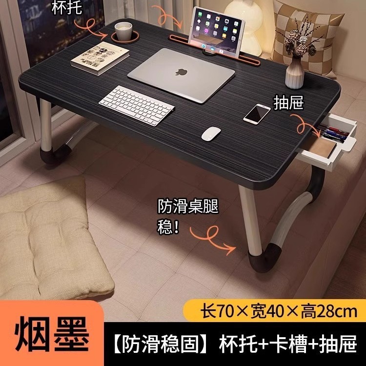 折り畳み可能なベッドの上の小さなテーブルは机のノートパソコンのテーブルを勉強します。|undefined