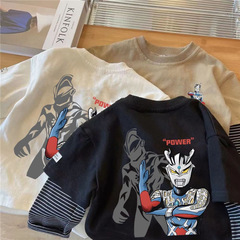 純綿の子供の長袖のtシャツの韓国版の偽の2つの小さい子供の丸首は漫画の春秋の子供の上着の男の子のtをつなぎ合わせます。