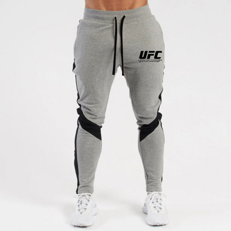 Otoño e invierno letras deportivas juventud ordinaria media elástica Mediados de cintura pantalones de algodón negro en stock moda de lana pantalones de los hombres