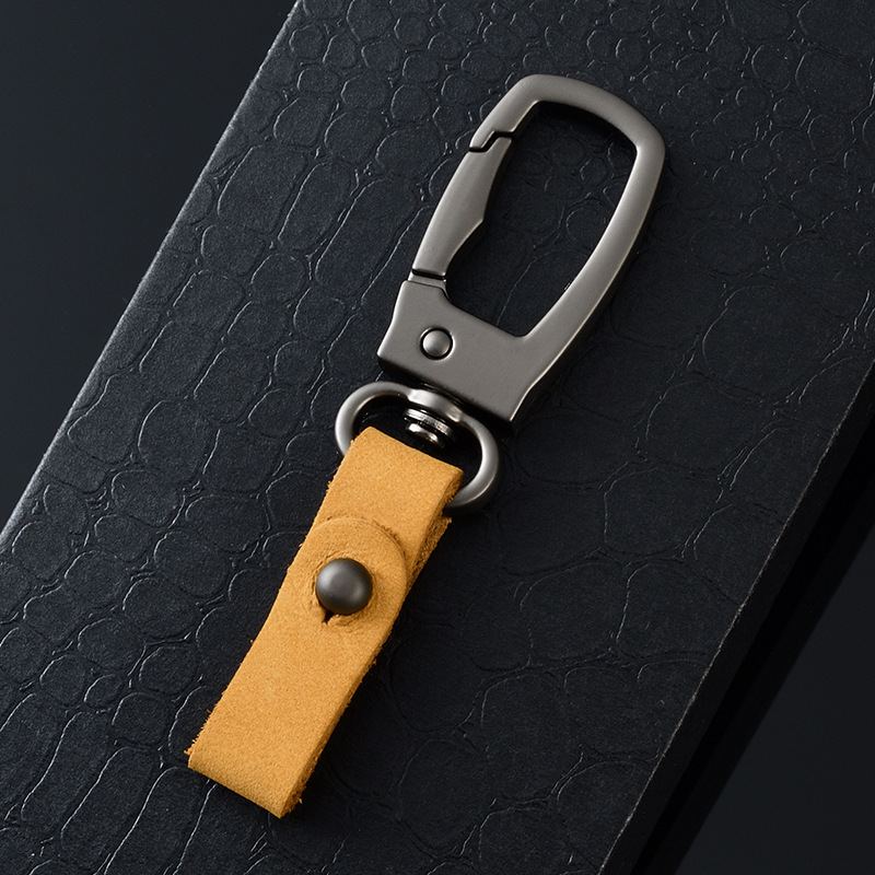 軽くて豪華な本革の自動車のキーホルダーの頭の層のつや消しの牛革の車のキーチェーンの個性のカップルの腰は掛けてペンダントをなくします。