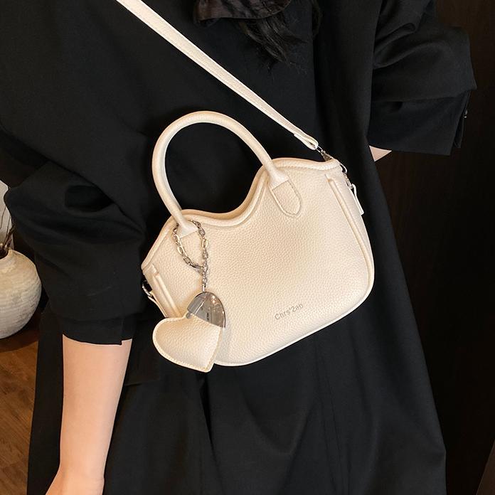 Bolsos pequeños de moda súper calientes de nicho para mujer 2025 nueva tendencia bolsa de cubo de aire extranjero estilo caliente de verano bolso de hombro de mano