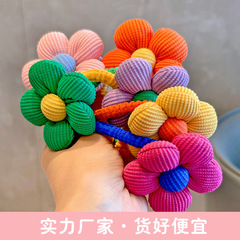 子供の女の子の頭ひもがかわいい綿の花が頭の輪ゴムを刺して、学生の丸子の頭の馬尾の髪を傷つけない