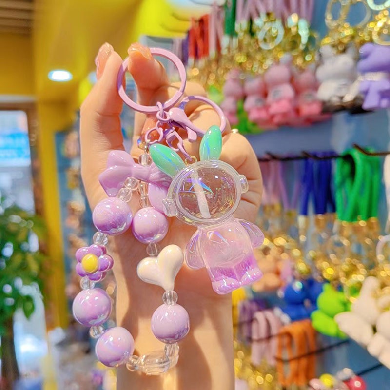 Nuevo colorido cuentas para usar auriculares bolsos de resina de conejo aeroespacial colgante de dibujos animados conejo llavero accesorios para estudiantes