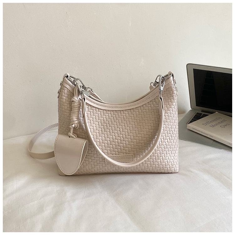 Nicho de diseño de hombro brazalete para mujeres 2026 verano nueva moda trenzada mochila de viaje ocio bolsa de mano