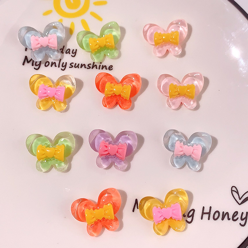 Nuevo color transparente mariposa arco DIY accesorios de resina pegamento crema caja de teléfono móvil adornamiento de pelo agujero material de parche de zapatos agujero