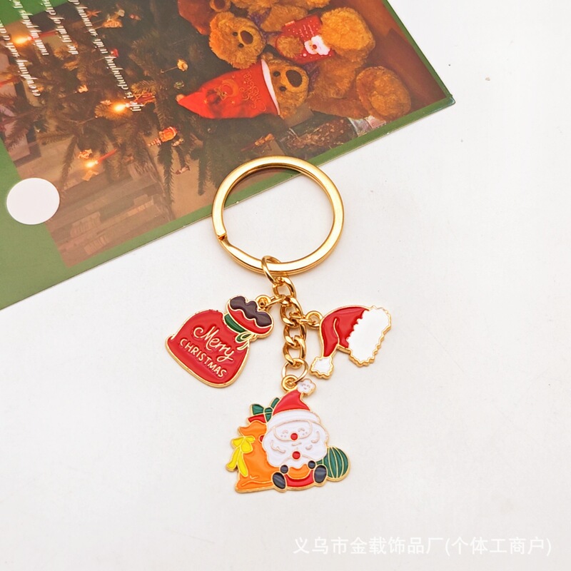 クリスマスのキーチェーンのクリスマスツリーは精巧なサンタクロースのヘラジカのプレゼントの箱の鈴のアクセサリーの包みのペンダントを飾ります。|undefined