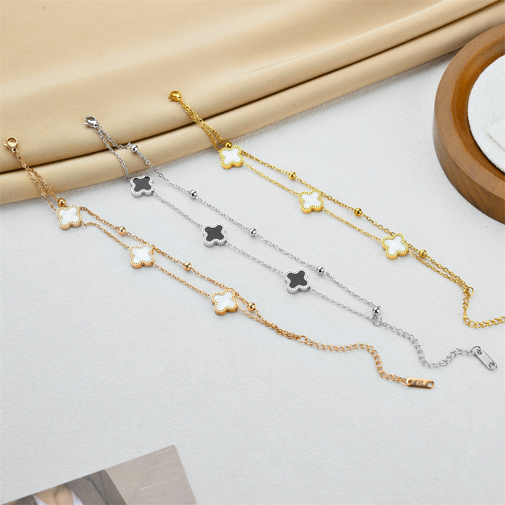 Ventas transfronterizas calientes de acero de titanio negro y blanco pulsera de cuatro hojas de doble capa de cadena de bola de acero oro rosa nicho de alta calidad joyas de pulsera