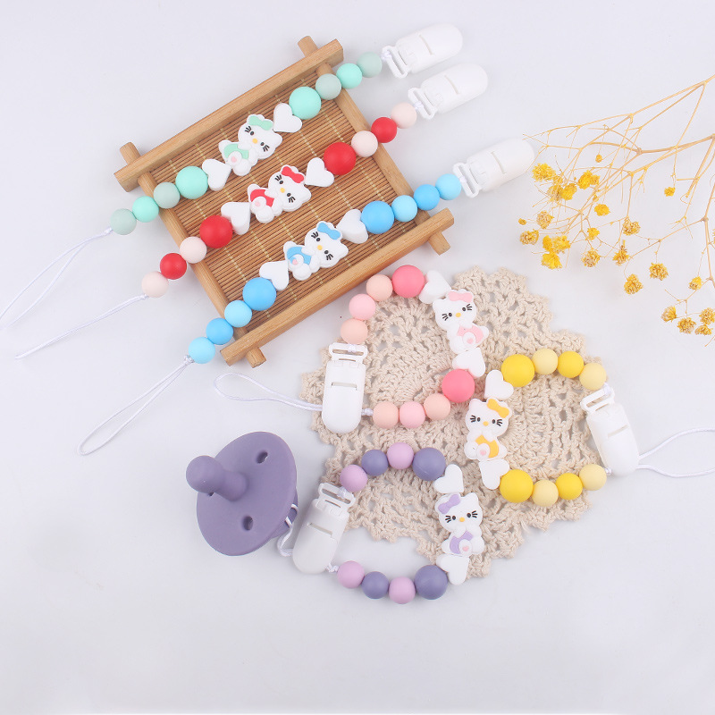 Nuevo KT gatos niños de silicona chupeta clips cadena bebé mordida cadena de dientes molares cadena anti-caída cadena pacificadora chupeta de goma de dente