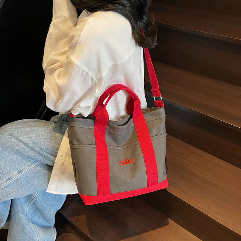 Bolso Tote de moda coreana 2025 verano nuevo estilo bolso de hombro estilo universitario bolso de mensajero de lona de color de contraste mujer