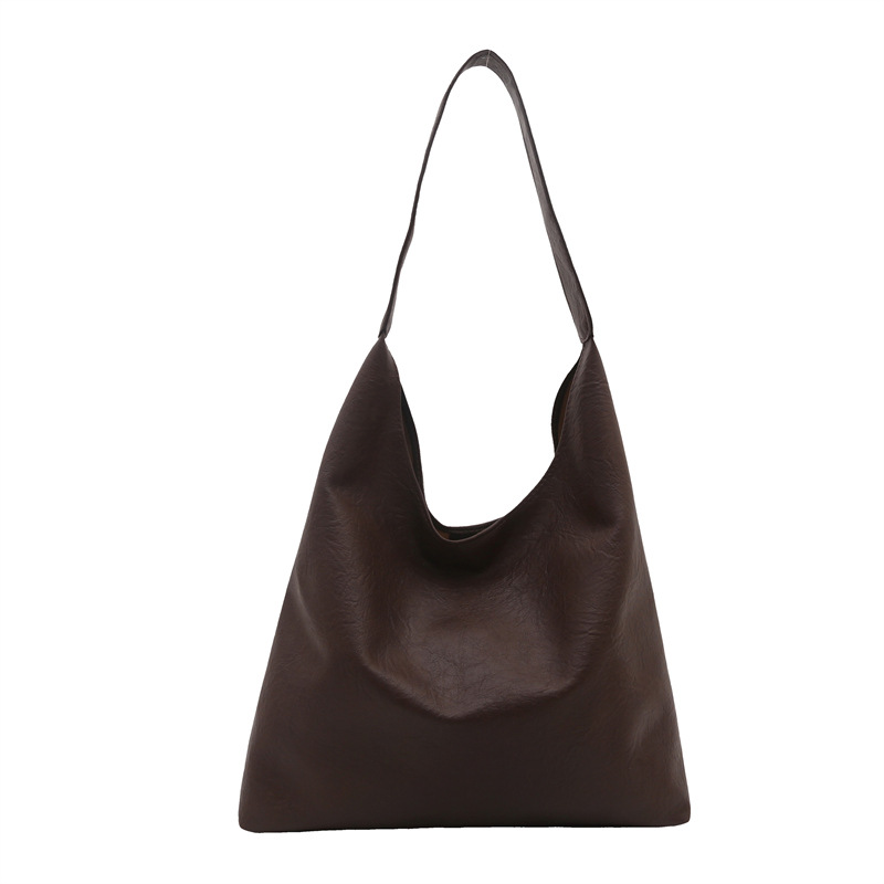 Bolso de mujer retro de gran capacidad de superficie suave casual 2024 nuevo estilo otoño e invierno bolso de hombro con patrón de agarre de mano moda bolso de cubo Tote