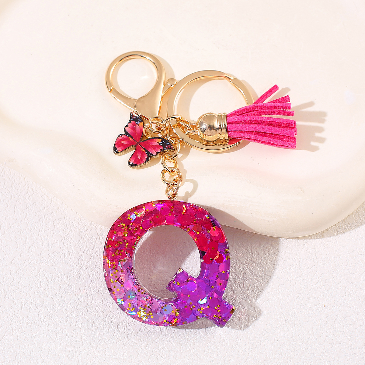 Transfronterizo Amazon 26 letras llavero de goteo de goma esquinilla gradiente letras mariposa llavero bolso de mujer colgante