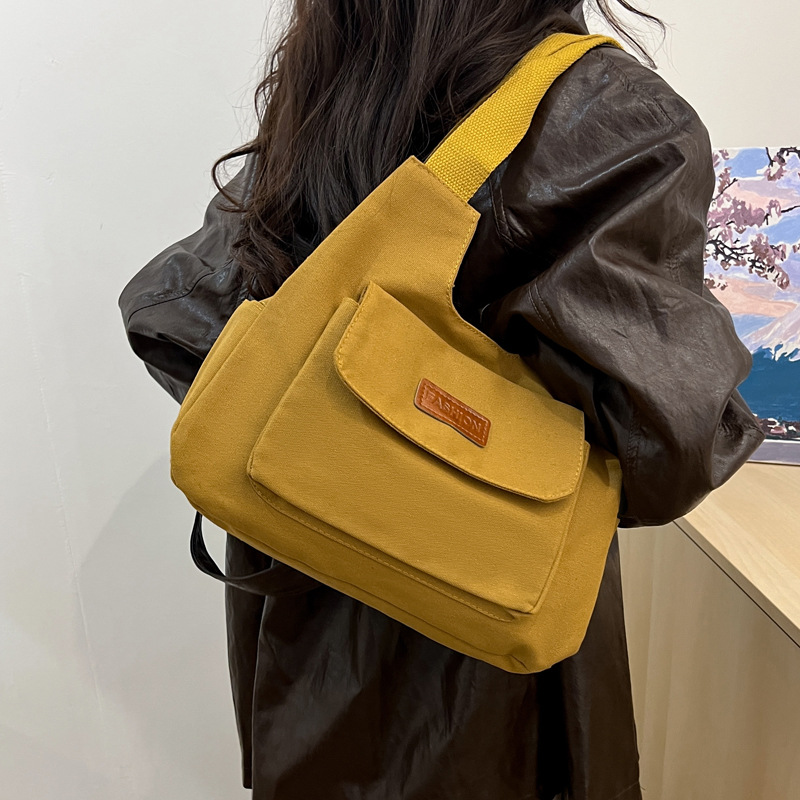 Bolsa de lona de gran capacidad para mujeres otoño-invierno 2024 nuevo estilo tideins viento brazalete bolsa de ocio estudiante bolsa de tote minimalista viento