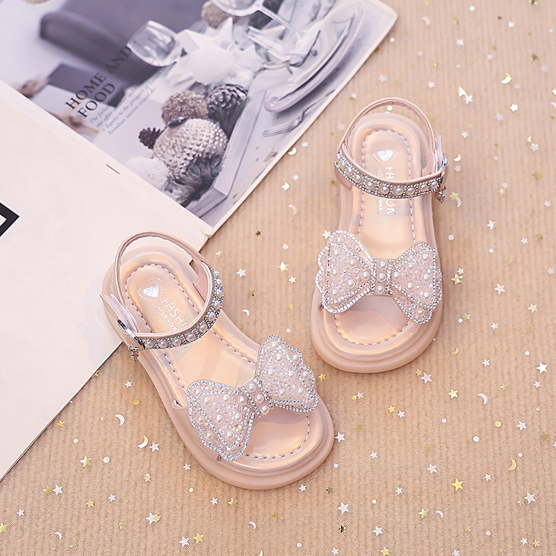 Niños verano 2026 nuevas sandalias de niñas arco brillante con base suave princesa sandalias de viento para niñas sandalias