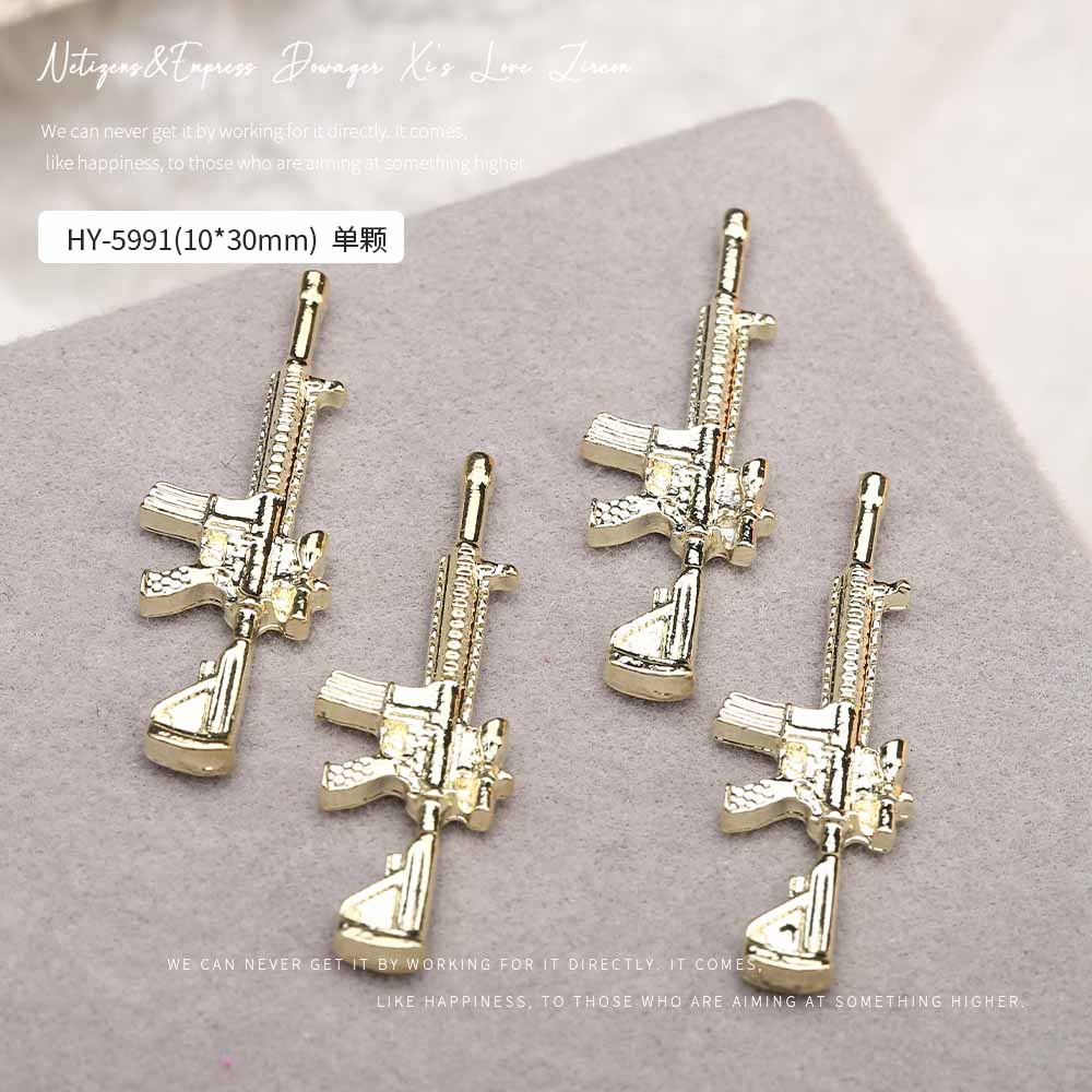 Europa y los Estados Unidos en línea con diamantes AK armas de manicuría joyas de simulación de personalidad tridimensional armas de fuego decoración de uñas al por mayor